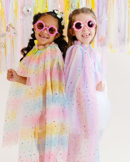 Girls wearing brightly colored tulle capes 