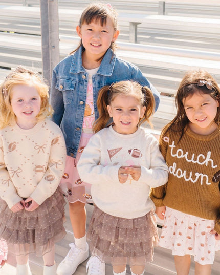 Girls wearing fun football themed outfits 