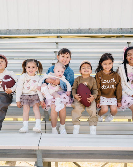 Kids wearing fun football themed outfits 