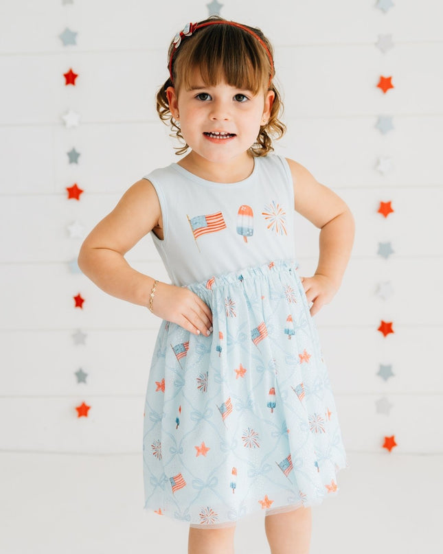 Girl wearing blue dress with patriotic pattern