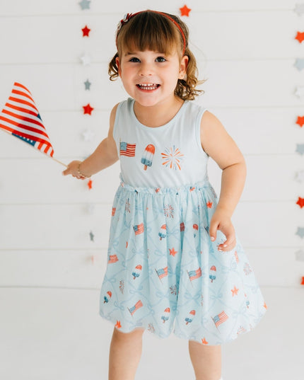 Girl wearing blue dress with patriotic pattern