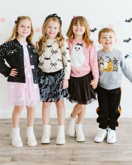 Four children wearing fun Halloween outfits