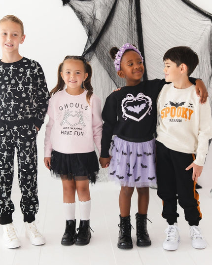 Four children wearing fun Halloween clothing. 
