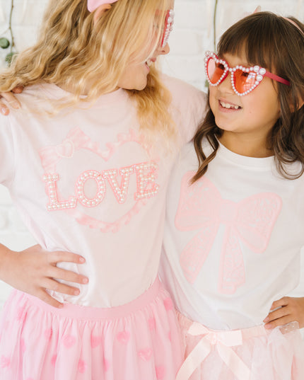 Girls wearing pink Valentine's Day outfits