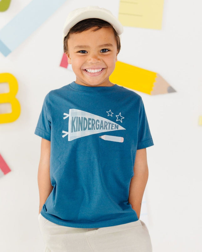 Boy wearing Blue t-shirt with 'kindergarten' pennant flag