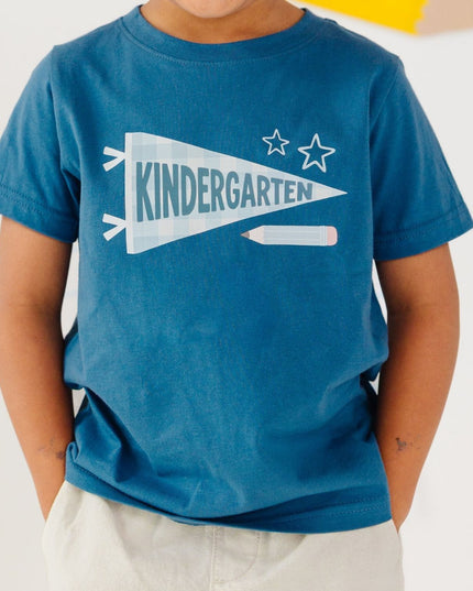 Boy wearing Blue t-shirt with 'kindergarten' pennant flag