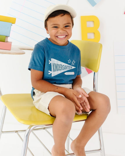 Boy wearing Blue t-shirt with 'kindergarten' pennant flag