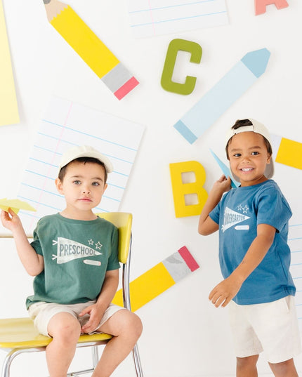 Boys wearing t-shirts with 'preschool' and 'kindergarten' banners