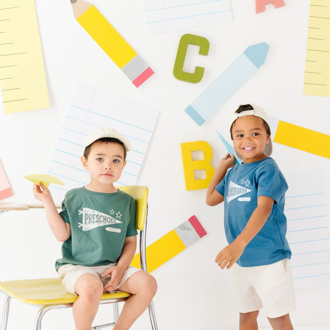 Boys wearing t-shirts with 'preschool' and 'kindergarten' banners
