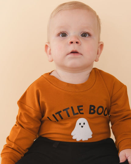 Baby wearing Orange baby romper with 'LITTLE BOO' text and ghost patch