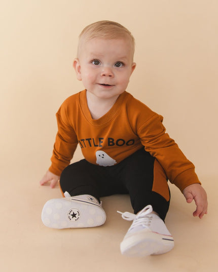 Baby wearing Orange baby romper with 'LITTLE BOO' text and ghost patch