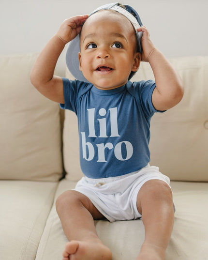 Baby wearing blue 'lil bro' bodysuit