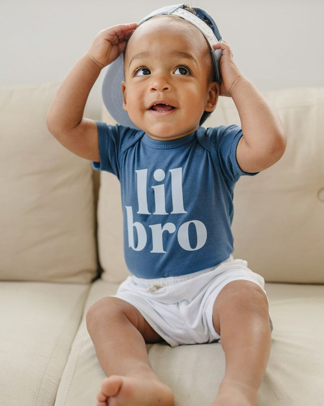 Baby wearing blue 'lil bro' bodysuit