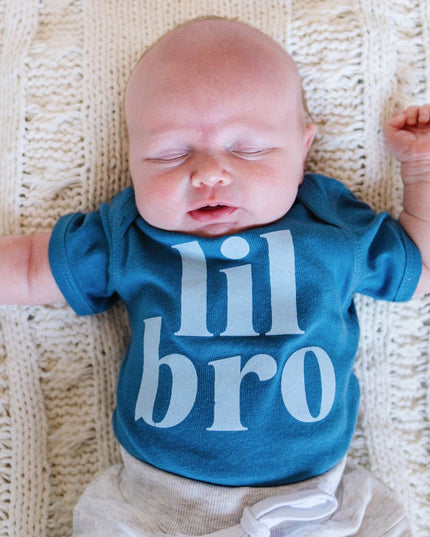 Baby wearing blue 'lil bro' bodysuit 