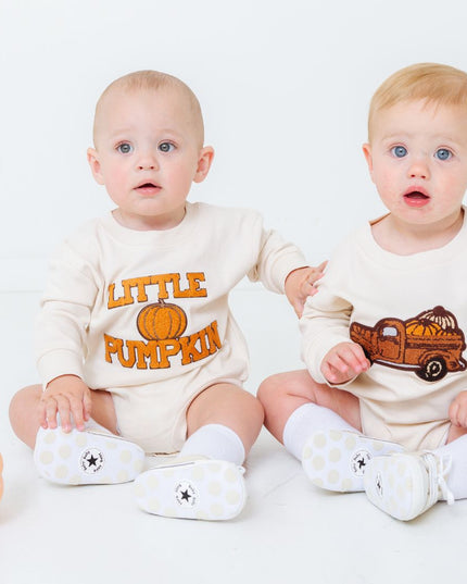 Babies wearing fall themed rompers