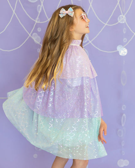 Girl wearing pastel mermaid cape