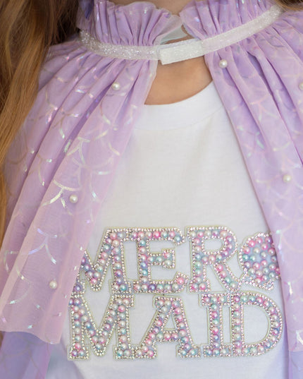 Girl wearing pastel mermaid cape and shirt