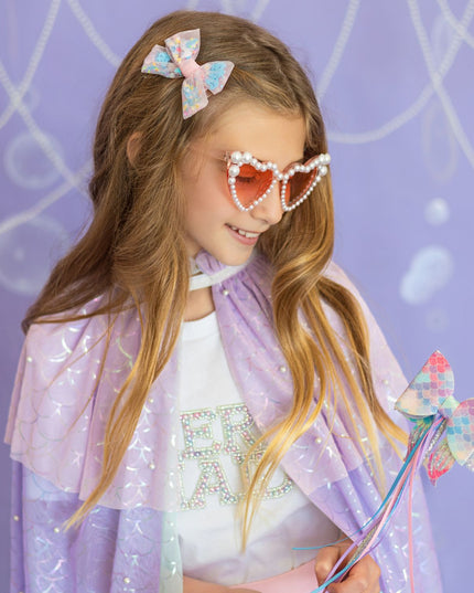 Girl wearing pastel mermaid cape