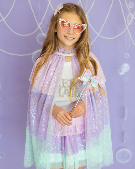 Girl wearing pastel mermaid cape