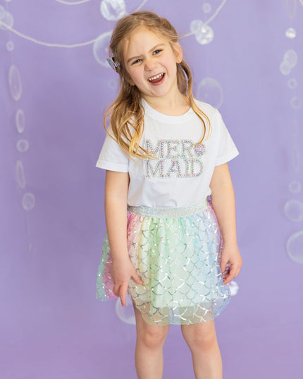 Girl wearing mermaid pearl patch shirt and rainbow mermaid tutu