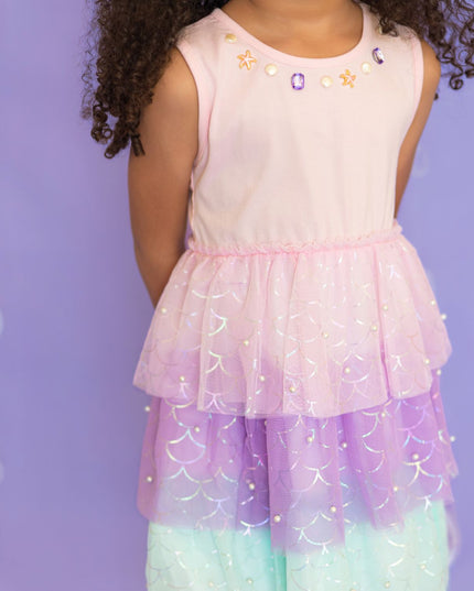 Girl wearing pink, purple, and green tutu mermaid dress.