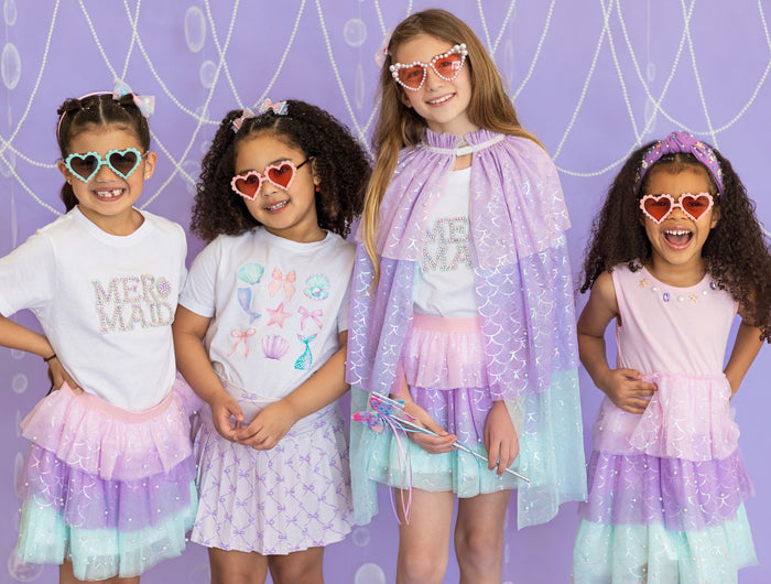 Four young girls wearing colorful mermaid inspired outfits