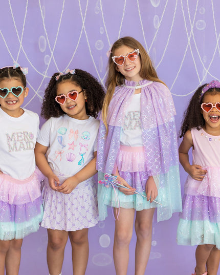 Four young girls wearing colorful mermaid inspired outfits