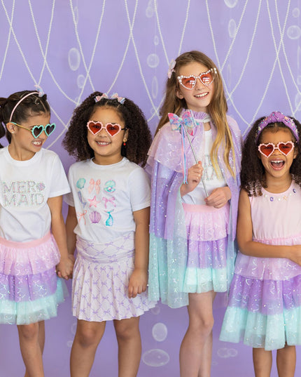 Four young girls wearing colorful mermaid inspired outfits