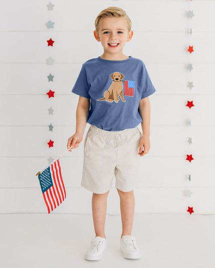 Boy wearing Blue shirt with dog holding American flag