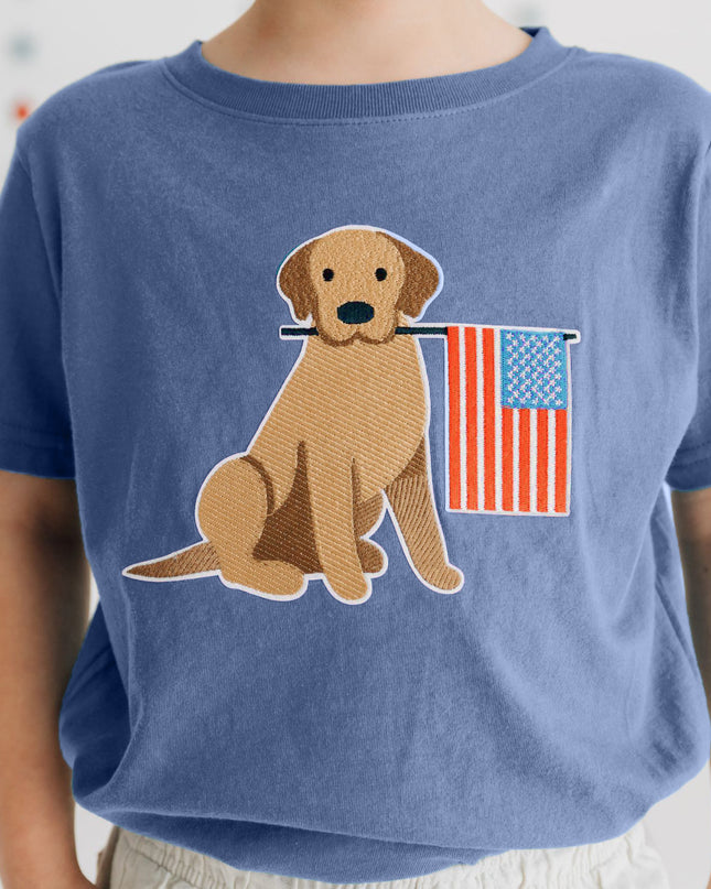 Boy wearing Blue shirt with dog holding American flag