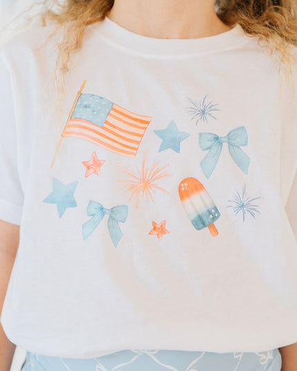 Girl wearing white t-shirt with red, white and blue graphic design