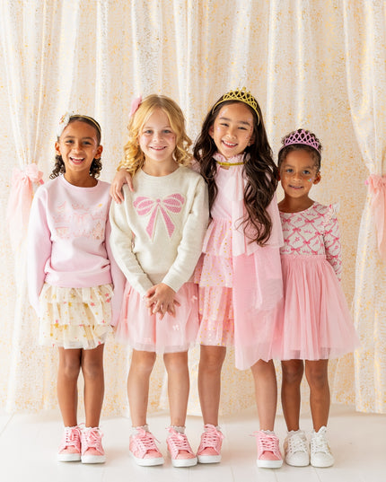 Girls wearing pretty pink dress up clothes