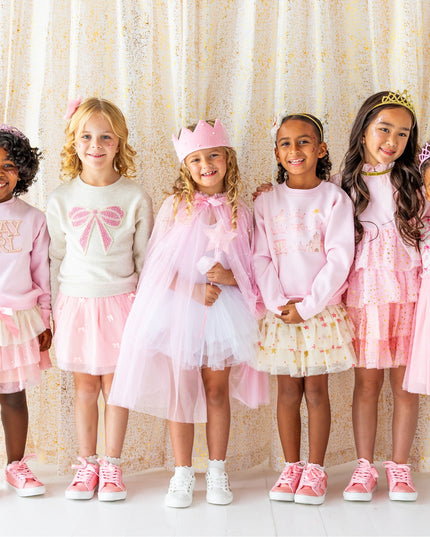 Girls wearing fun pink and pearl outfits