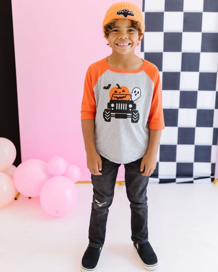 Boy wearing Halloween T-shirt with truck, pumpkin, ghost and bat graphic