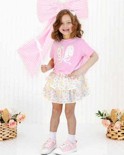 Girl wearing floral skort and pink bunny ear tee shirt
