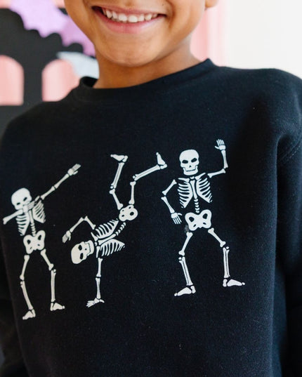 Boy wearing Black Sweatshirt with dancing skeletons 