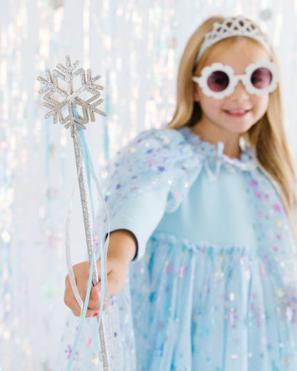 Girl wearing blue outfit and holding silver snowflake wand