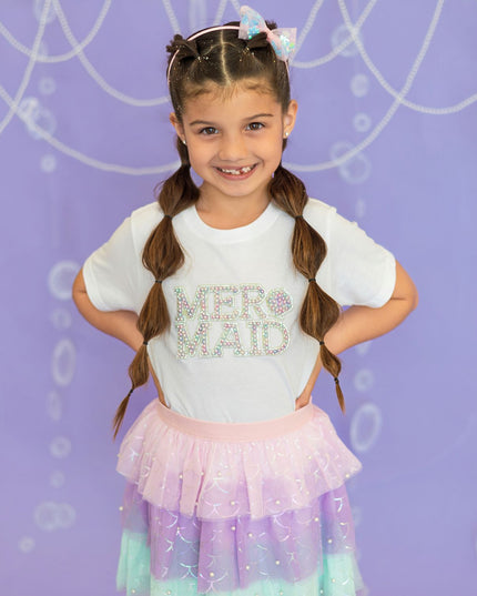 Girl wearing white t-shirt with pearl mermaid patch and mermaid tutu