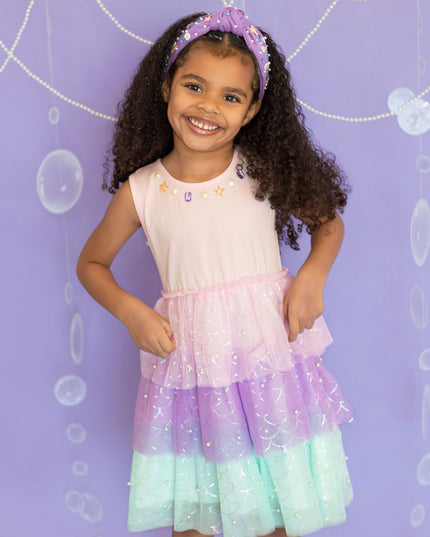 Girl wearing pink, purple, and green tutu mermaid dress 