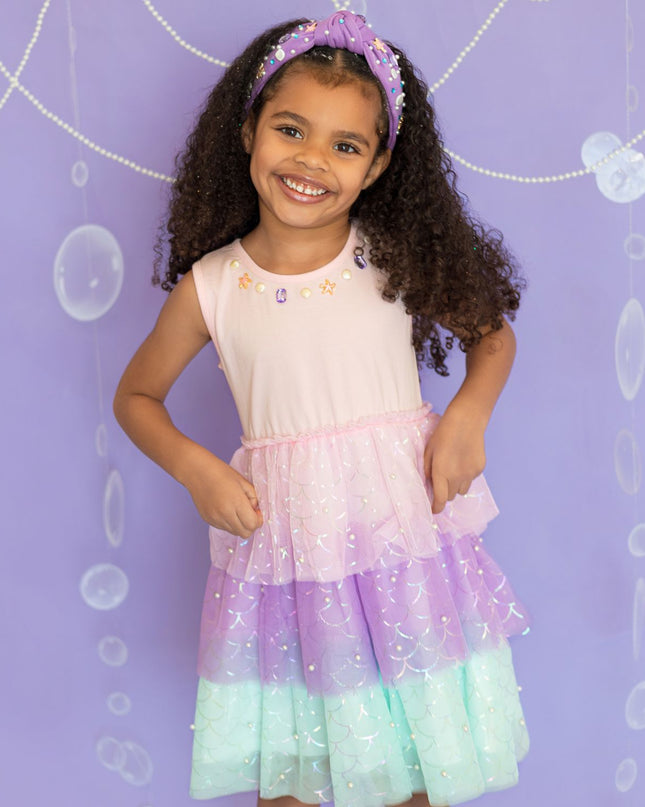 Girl wearing pink, purple, and green tutu mermaid dress 
