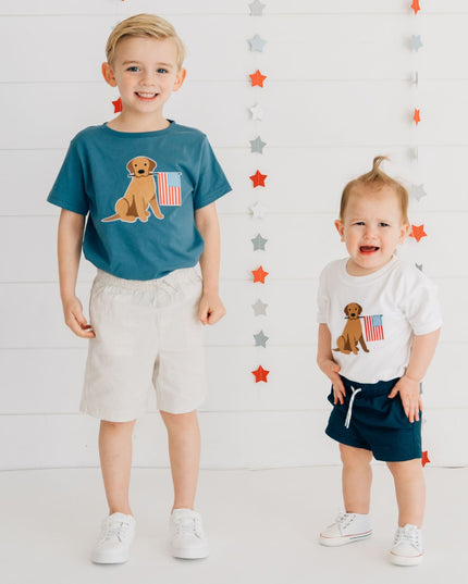 Boys wearing shirts with dogs holding American flag