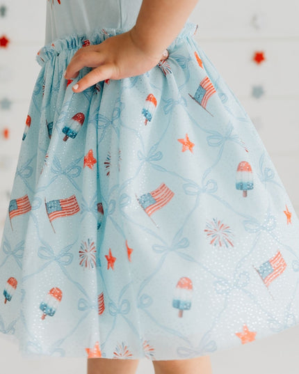Girl wearing blue dress with patriotic pattern