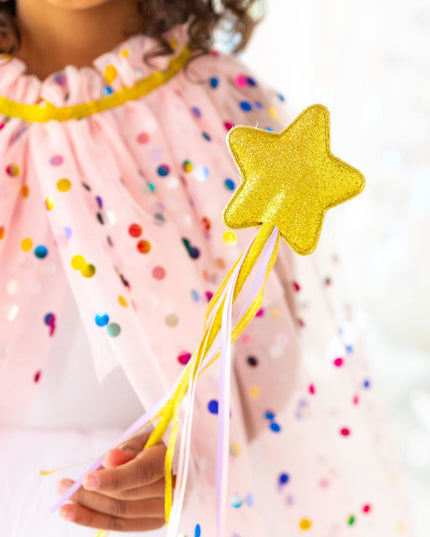 child holding gold star wand