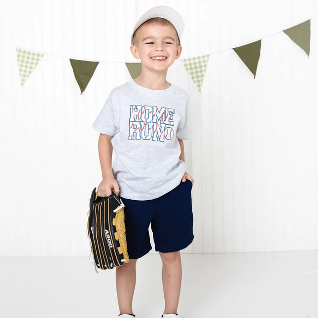 Boy wearing grey T-shirt with home run baseball patch