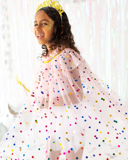 Girl wearing pink polka dot cape