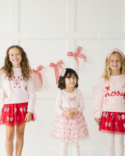 Girls wearing festive and fun Christmas outfits