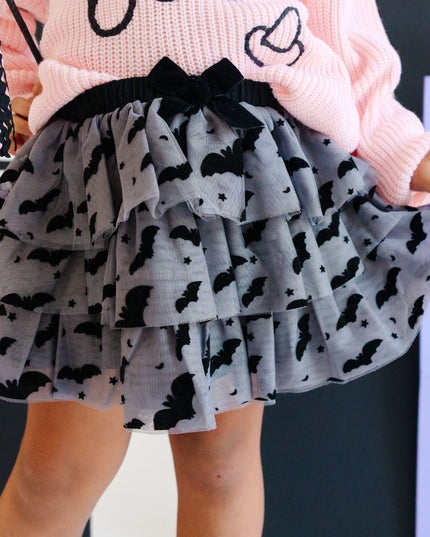 Girl wearing Dark grey tulle tutu with black velvet bats, stars and moons