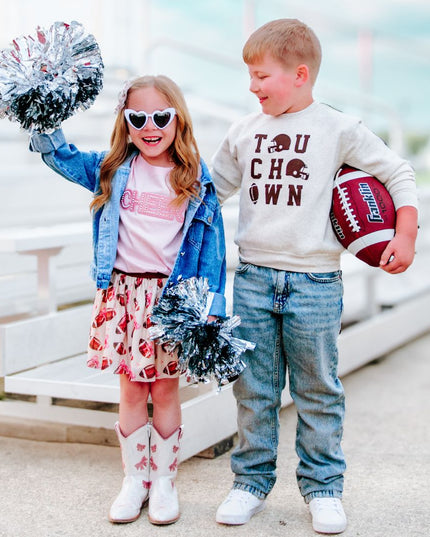 Girl wearing cheer outfit and boy wearing Touchdown Football Sweatshirt