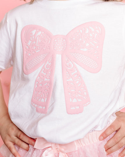 Girl wearing white t-shirt with pink lace bow 