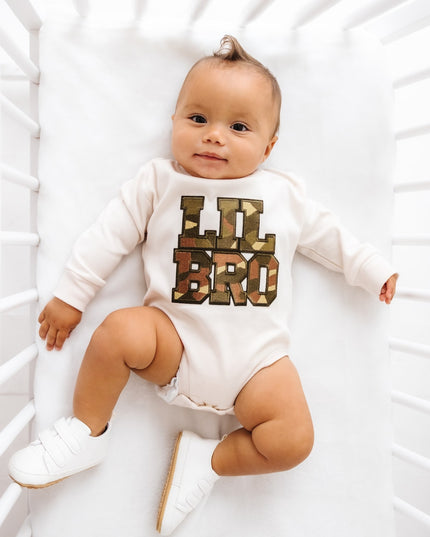 Baby wearing romper with camouflage Lil Bro Patch design